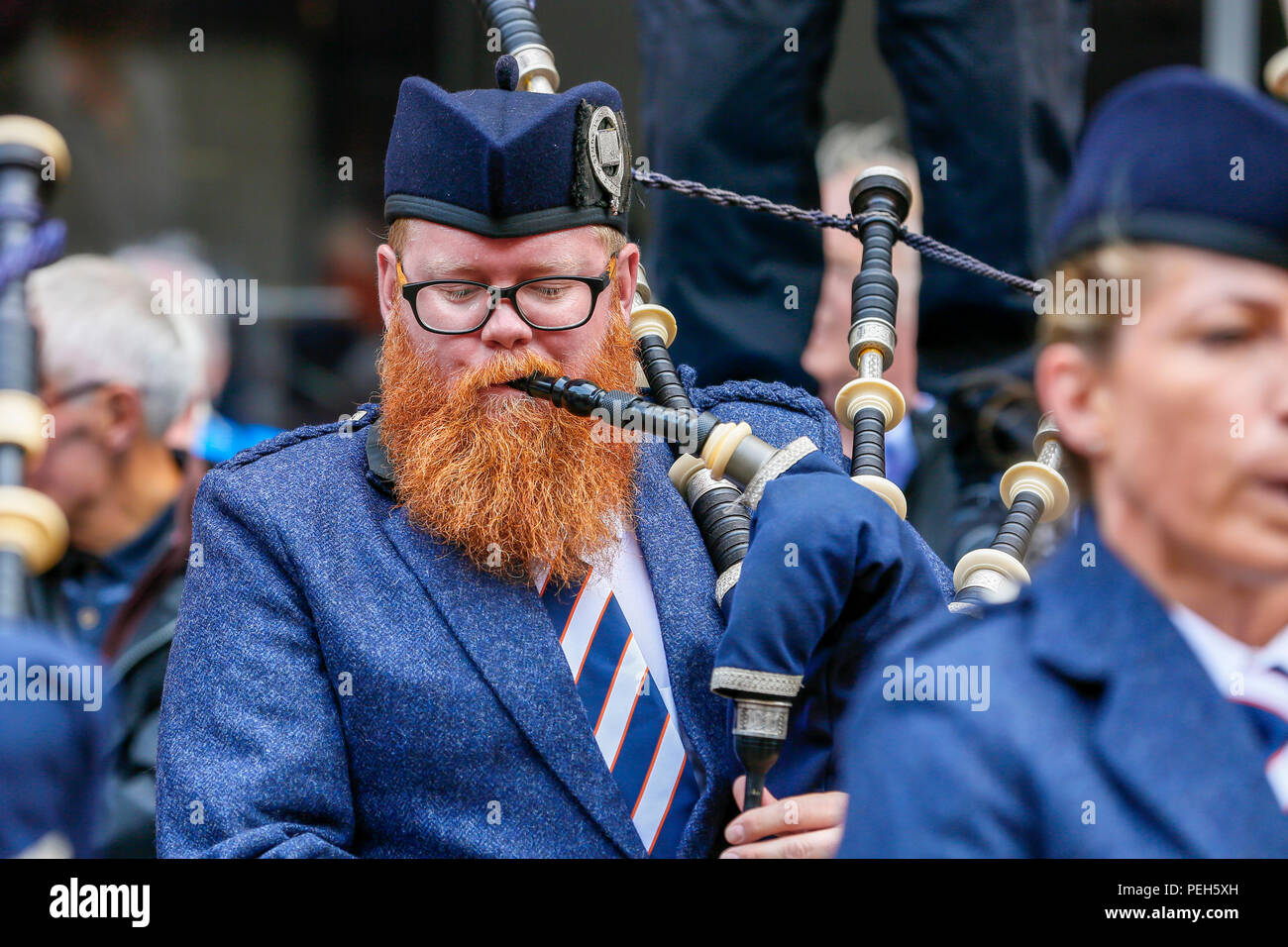 Glasgow, UK. 15th Aug 2018. Street performances continue in Buchanan Street, Glasgow with more international pipe bands playing near the Donald Dewar statue to entertain the public for free. The Pipe Band championships conclude on Saturday 18th August at Glasgow Green. Picture of DAVID WELSH, originally from Aberdeen, now living in Wellington New Zealand and playing with the Simon Fraser University pipe band from British Columbia, Canada Credit: Findlay/Alamy Live News Stock Photo