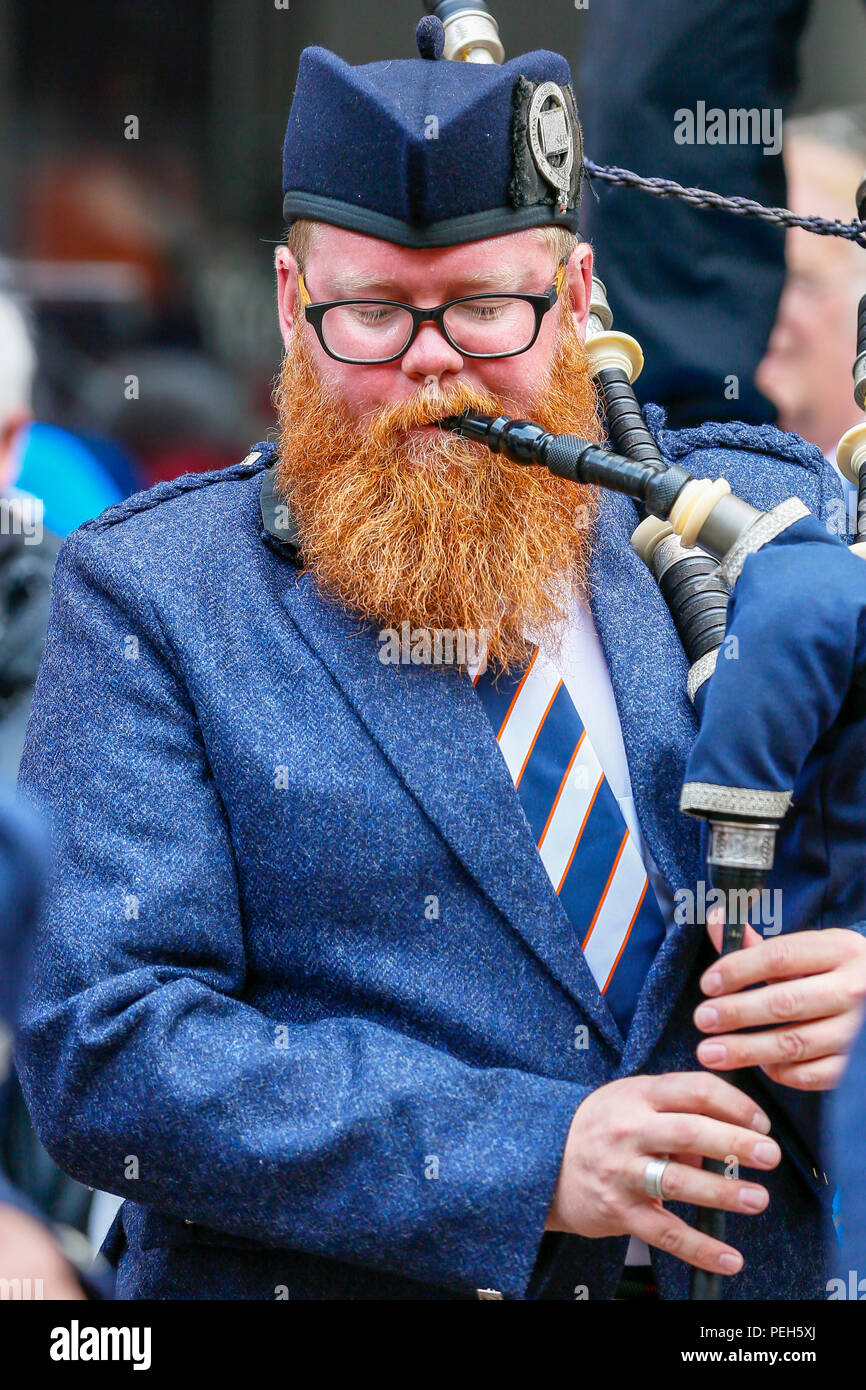 Glasgow, UK. 15th Aug 2018. Street performances continue in Buchanan Street, Glasgow with more international pipe bands playing near the Donald Dewar statue to entertain the public for free. The Pipe Band championships conclude on Saturday 18th August at Glasgow Green. Picture of DAVID WELSH, originally from Aberdeen, now living in Wellington New Zealand and playing with the Simon Fraser University pipe band from British Columbia, Canada Credit: Findlay/Alamy Live News Stock Photo