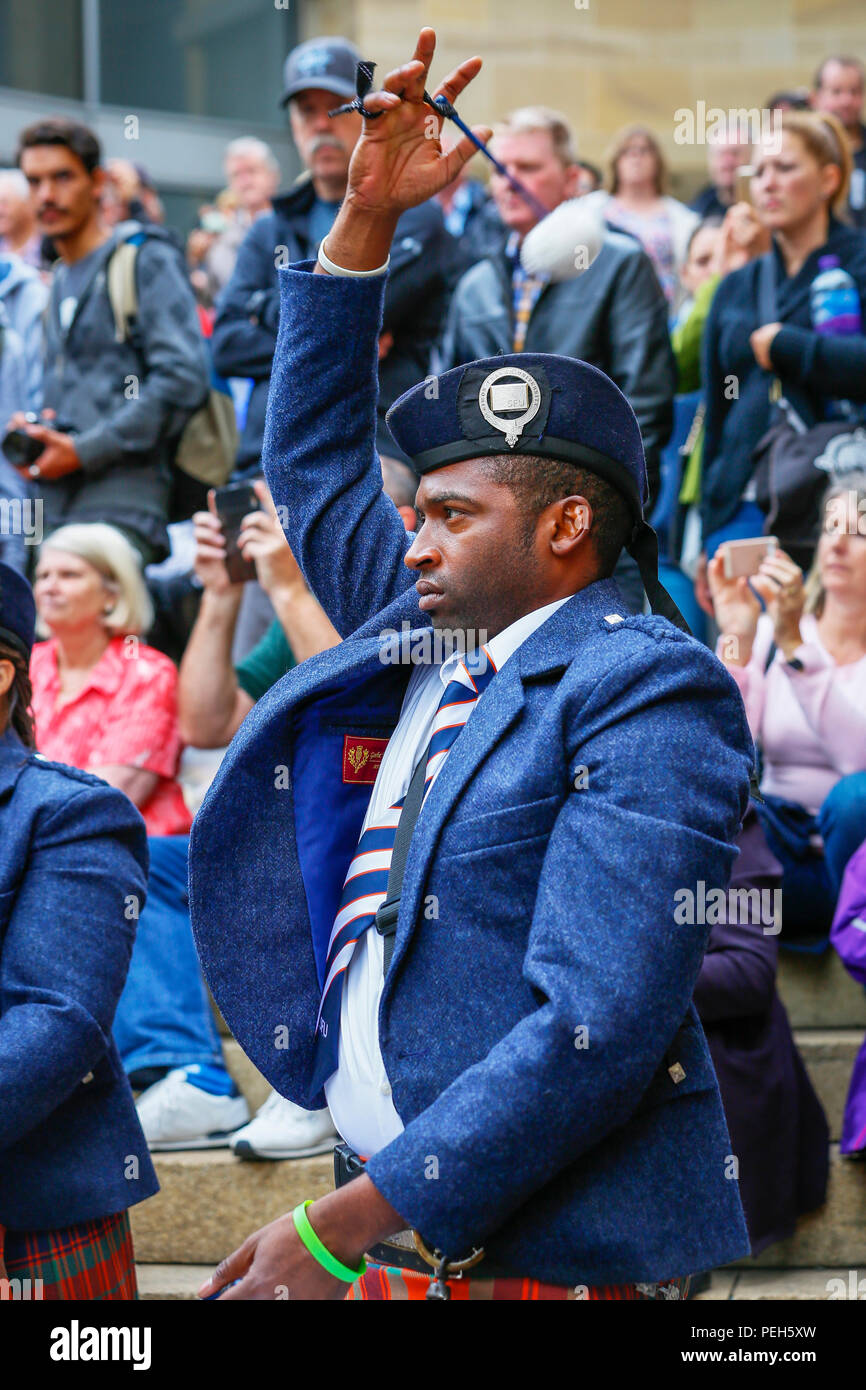 Glasgow, UK. 15th Aug 2018. Street performances continue in Buchanan Street, Glasgow with more international pipe bands playing near the Donald Dewar statue to entertain the public for free. The Pipe Band championships conclude on Saturday 18th August at Glasgow Green. Pictue of OWEN RUSSELL from USA playing with the Simon Frase University Pipe Band from British Columbia, Canada Credit: Findlay/Alamy Live News Stock Photo