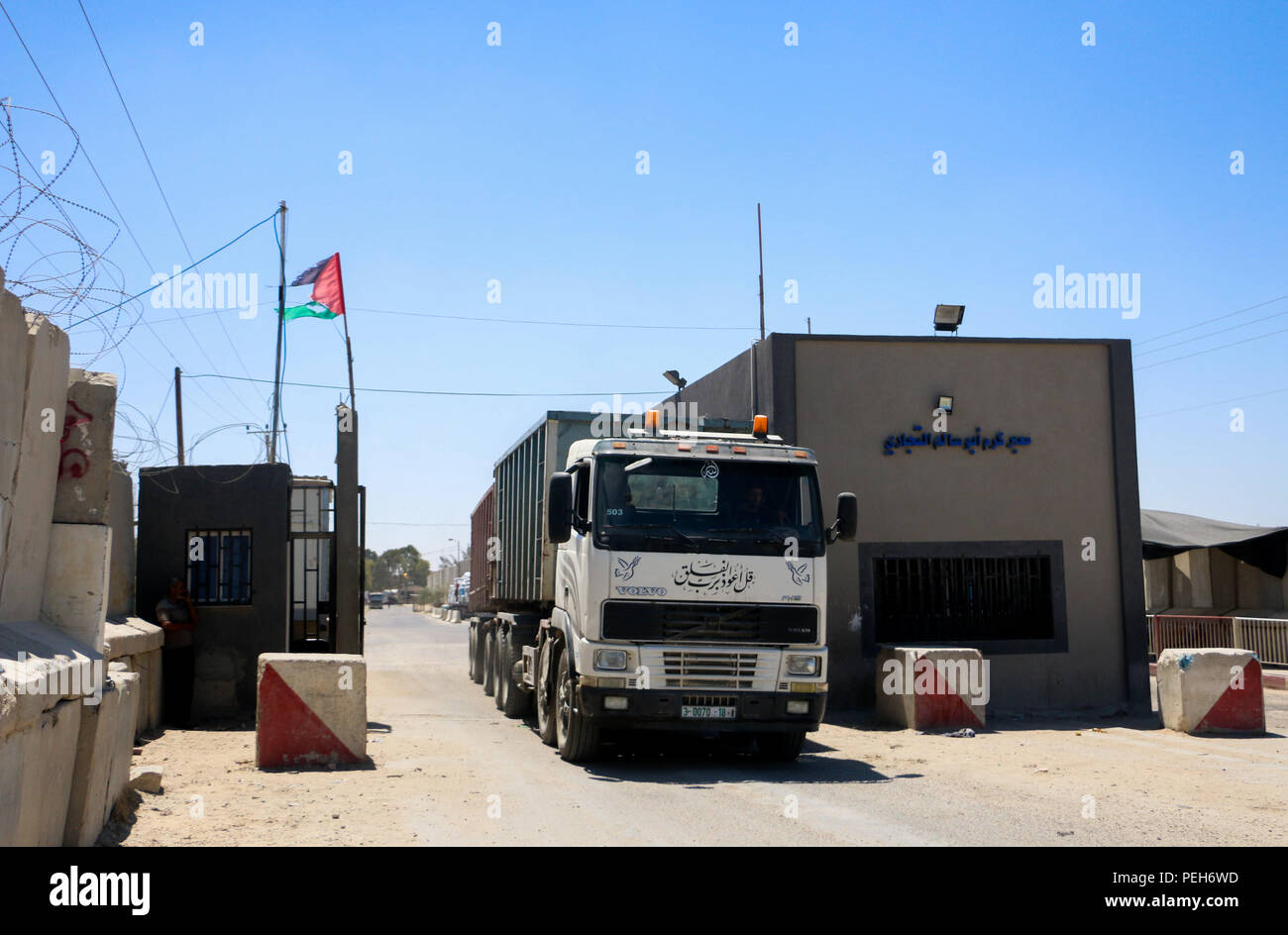 August 15, 2018 - Trucks carrying commercial goods enter Gaza through the Kerem Shalom crossing in Rafah, in the southern Gaza Strip, as Israel reopens the Kerem Salam crossing after nearly a month of closure. Israel had closed the crossing and suspended the import of fuel and gas on the besieged Gaza strip as punishing measures against the launch by Palestinians of incendiary balloons and kites from the strip into southern Israel. Of the two crossings into Gaza controlled by Israel, the Erez crossing in the northern Gaza Strip is specifically for pedestrians, while the Kerem Shalom crossing i Stock Photo