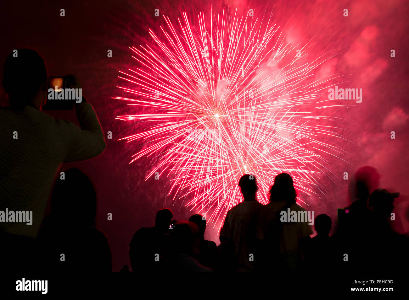 Ottawa, Canada. August 15, 2018. Spectators watch the Lac Leamy Sound of Light fireworks display put on by China. Credit: Vince F/Alamy Live News Stock Photo
