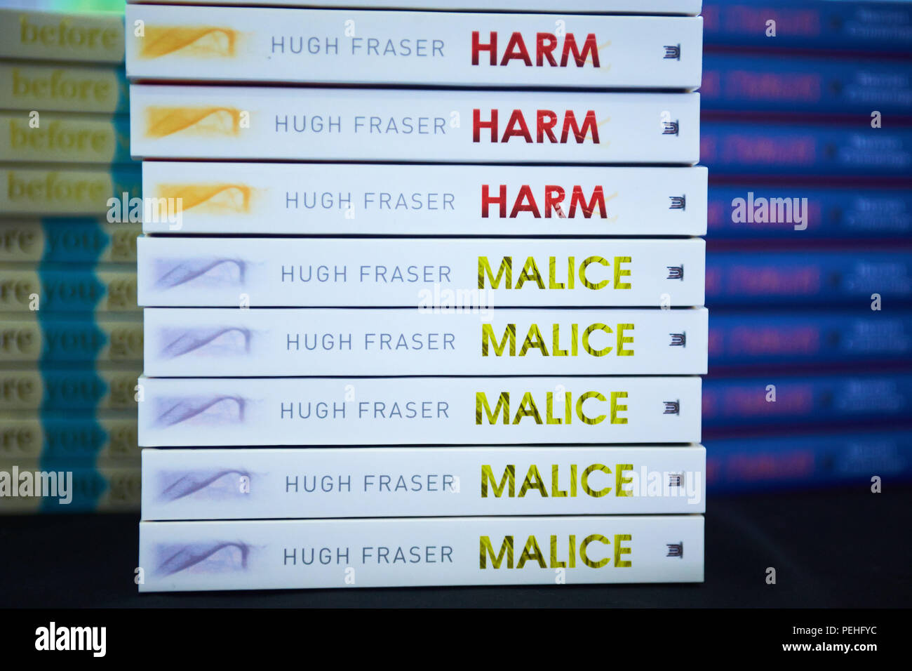A stack of books showing spines with the titles “Harm” and “Malice” by Hugh  Fraser Stock Photo - Alamy