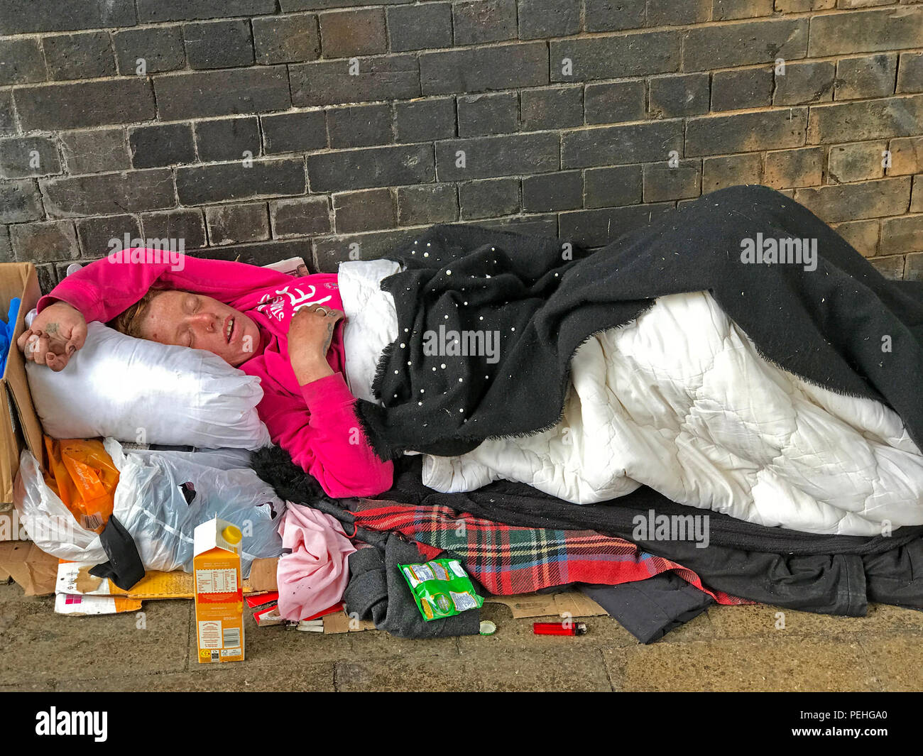 Rough sleeping homeless person, under a railway arch, Manchester, North West England, UK Stock Photo