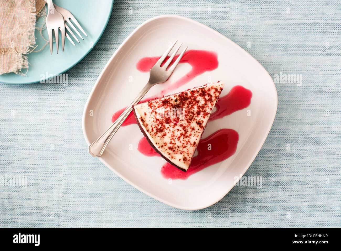 Red Velvet cake slice on blue background. Top view Stock Photo