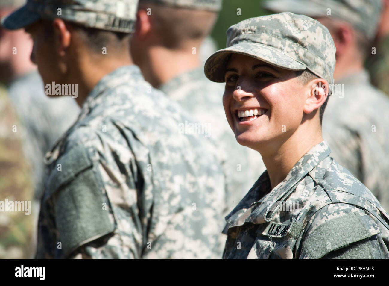 Capt. Kristen Griest smiles at friends and family as she waits with her  U.S. Army Ranger School Class 08-15 to graduate at Fort Benning, Ga., Aug.  21, 2015. Griest and class member