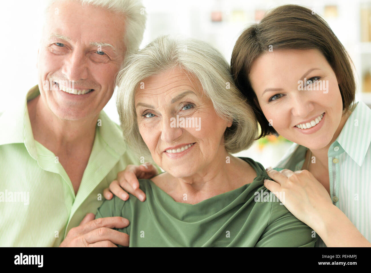 Happy senior parents with daughter at home  Stock Photo