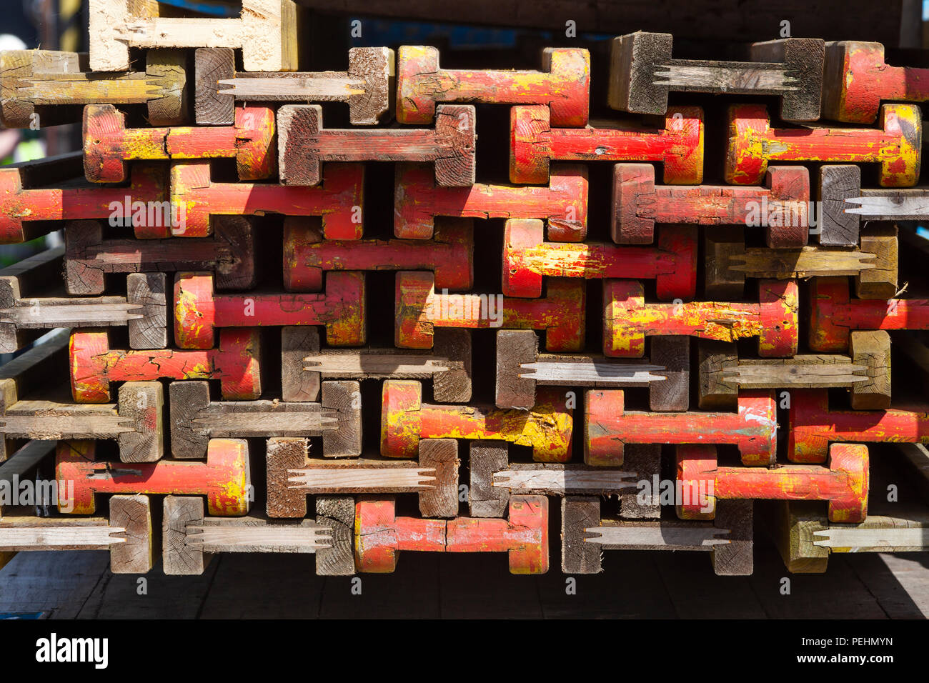 Stack of colorful wooden beams for building market stalls in the Netherlands Stock Photo