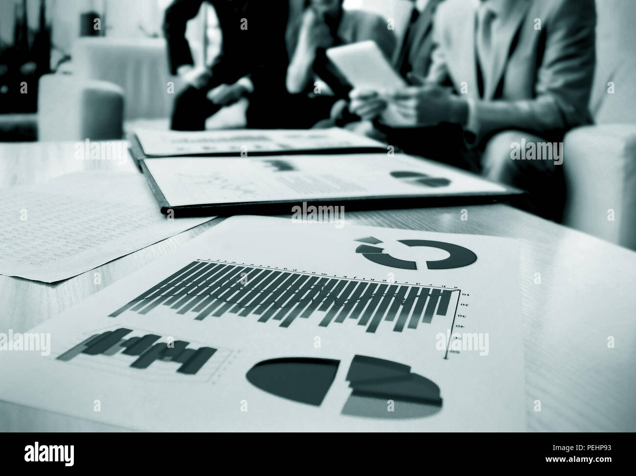 charts and graphs with documents in the background of the team Stock ...