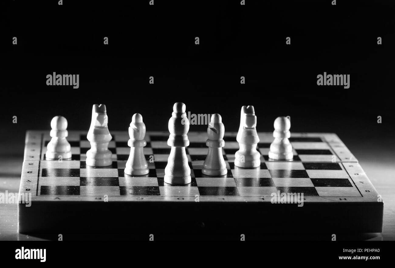 Composition with chessmen in the glossy chessboard Stock Photo
