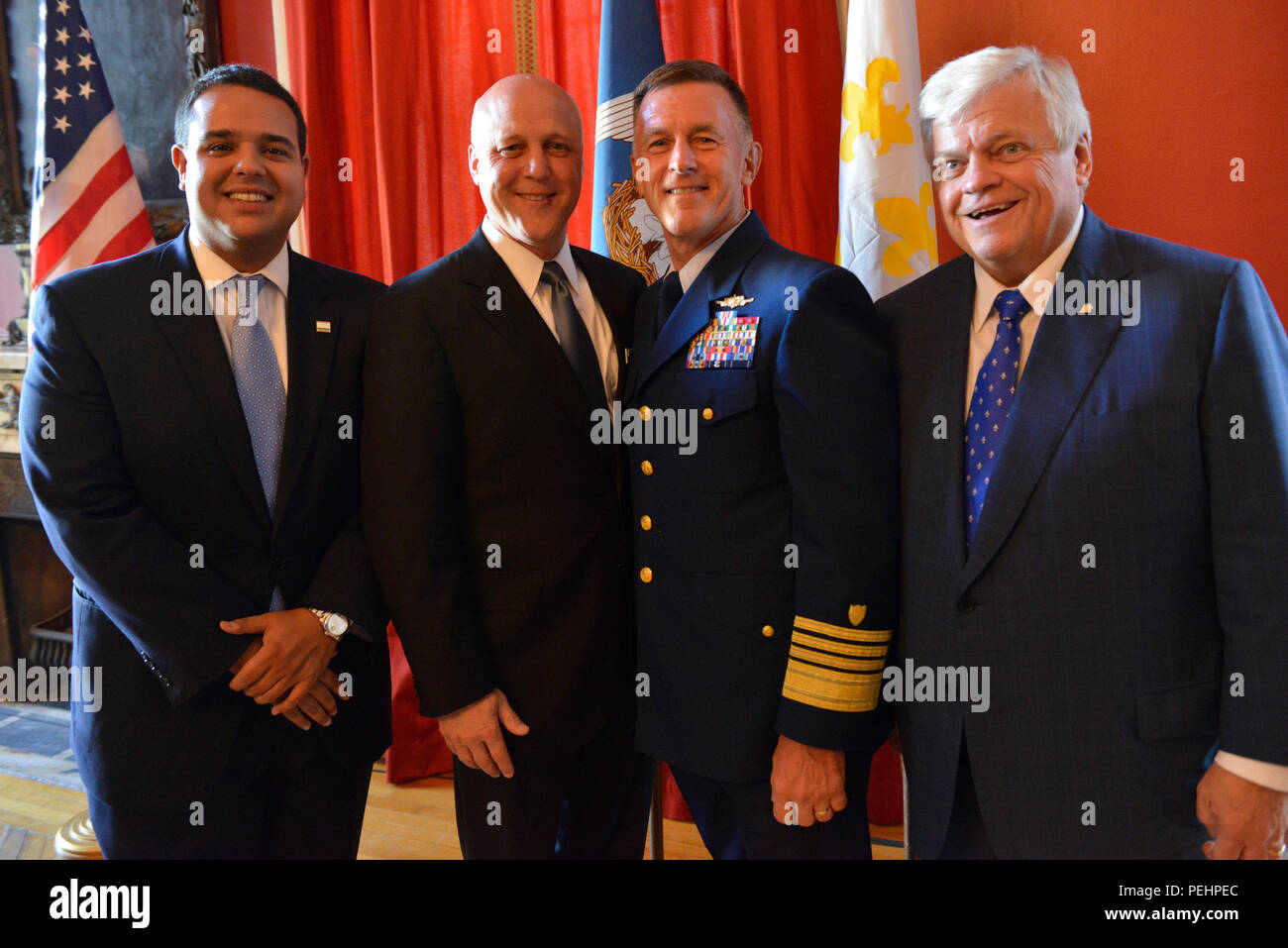 (From left to right) Jared Brossette, New Orleans City Councilman, New Orleans Mayor Mitch Landrieu, Adm. Paul Zukunft, commandant, U.S. Coast Guard and Richard E. Zuschlag, owner, Acadian Ambulance, pose for a picture at the Gallier Hall reception for Hurricane Katrina first responders, Friday. (U.S. Coast Guard photo by PA2 Seth Johnson) Stock Photo