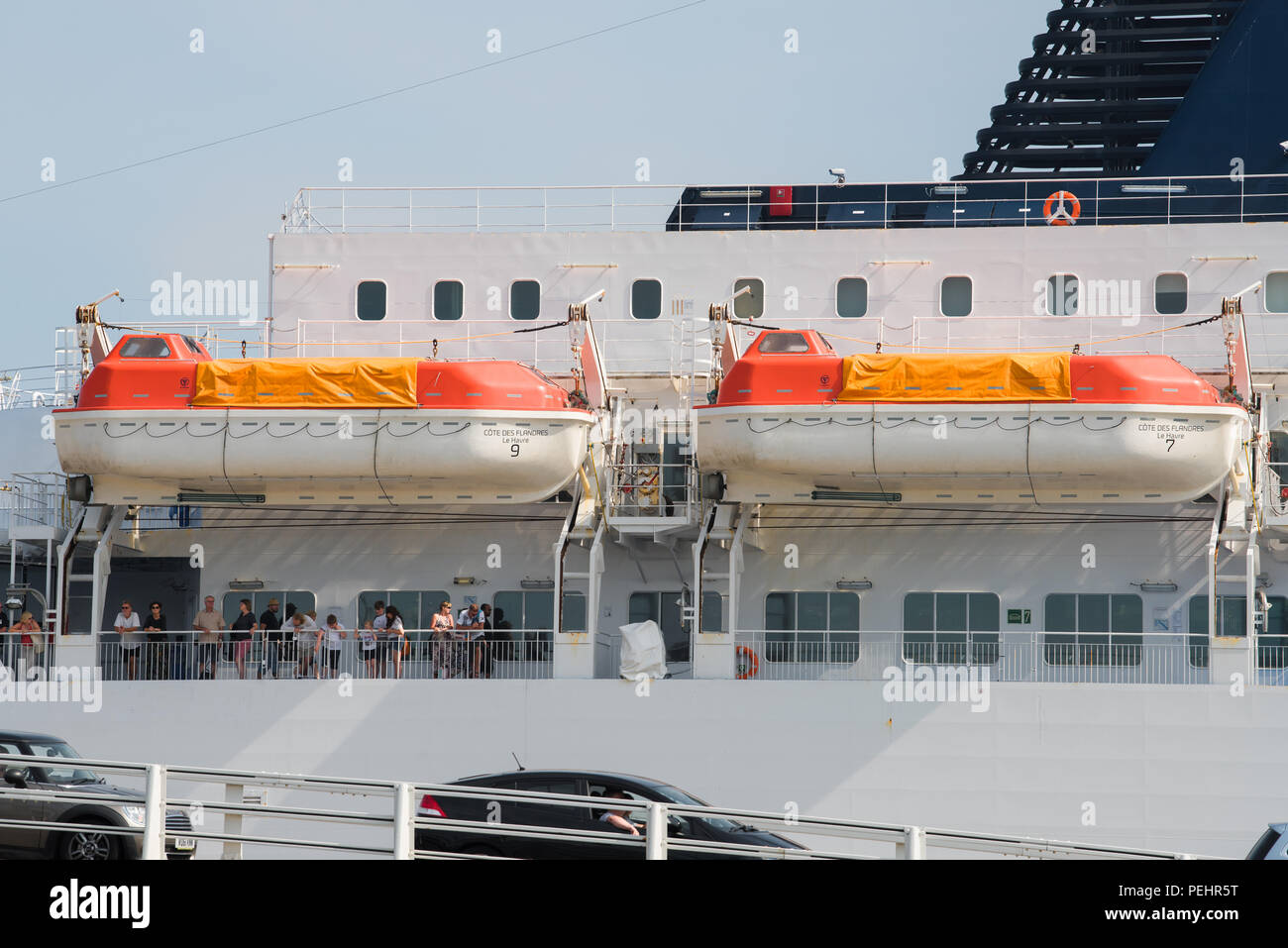 Two lifeboats above passengers on a ferry docked at the port of Calais, France. Stock Photo