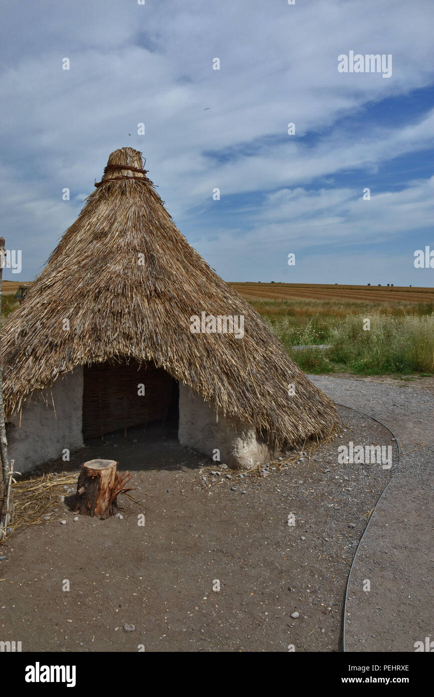 Rural stone age hut with a colorful sky Stock Photo