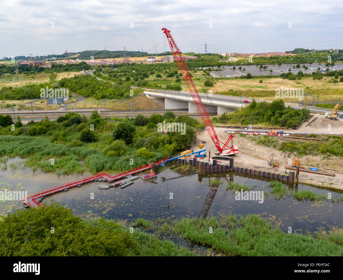 Aerial view of the start of the bridge installation between Springhead Park, and Ebbsfleet International train station, Kent, UK Stock Photo
