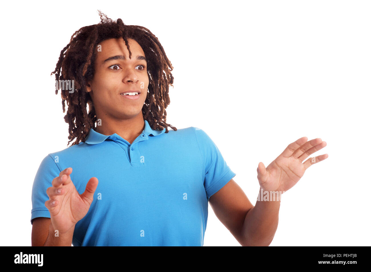 surprised young man posing against white background Stock Photo - Alamy