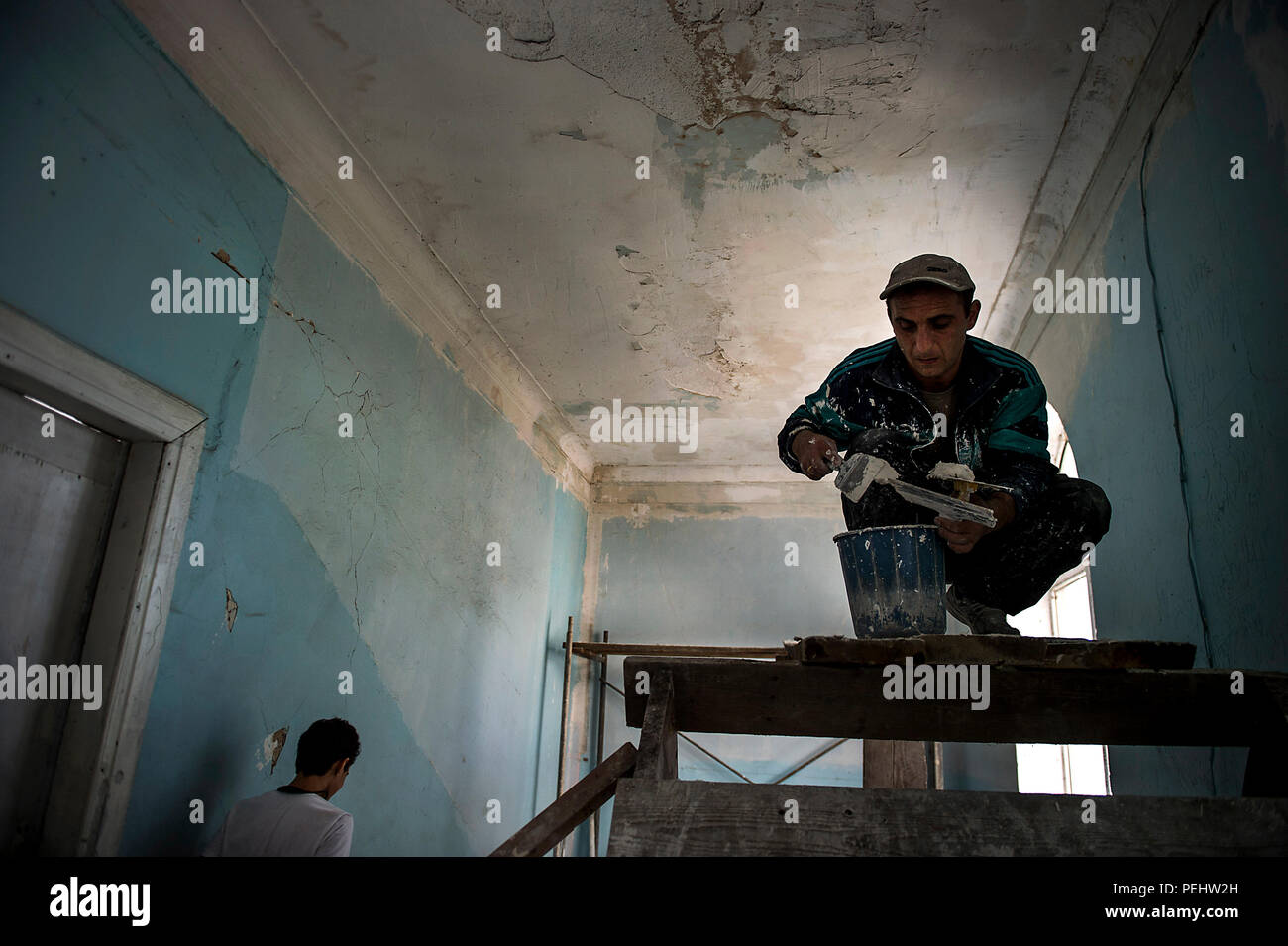Roin A Georgian Engineer Prepares Spackle Holes In The