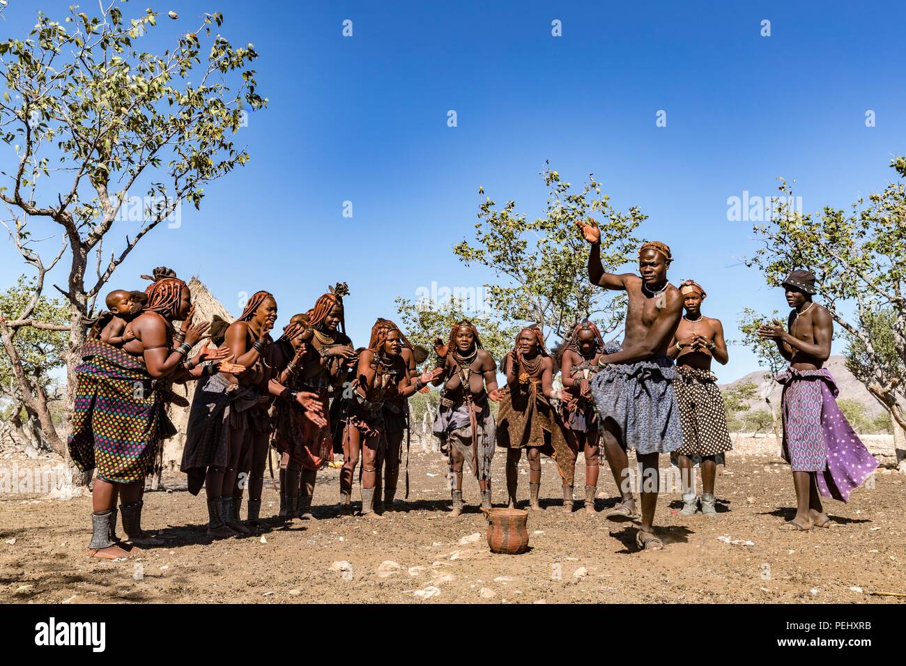 Himba tribes people performing a dance for visitors to their village Stock Photo