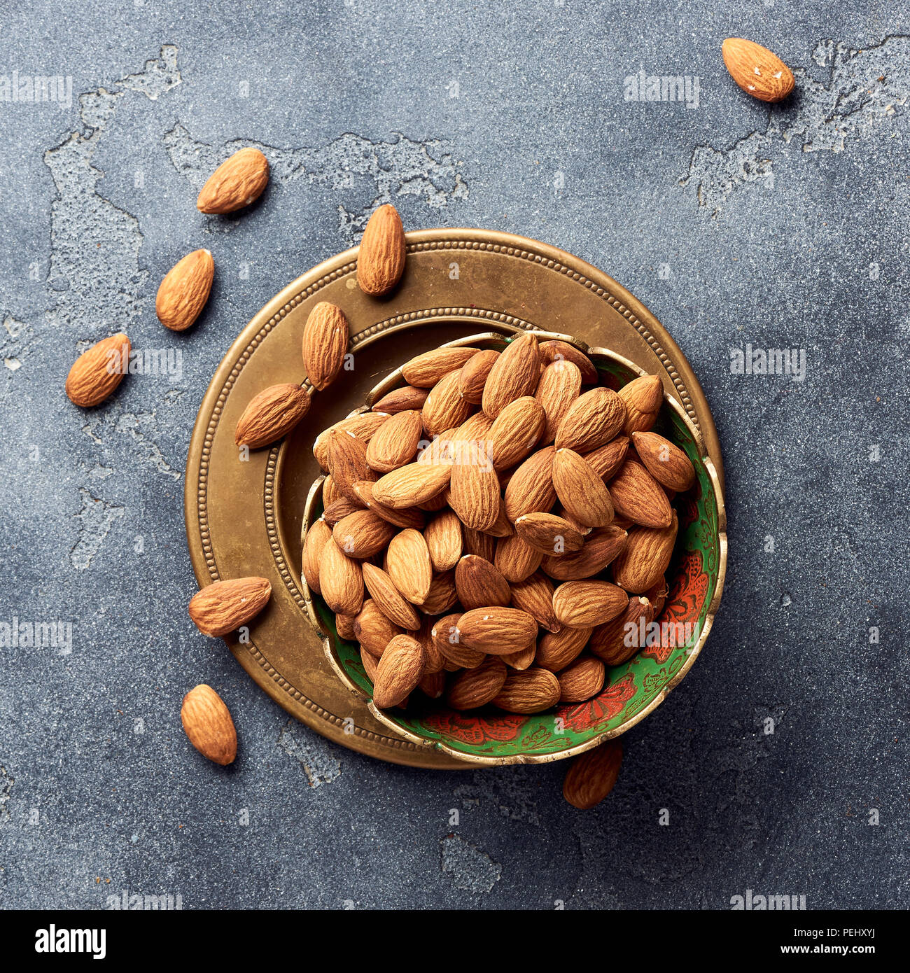 Almond nuts in bowl on gray background. Top view. Stock Photo