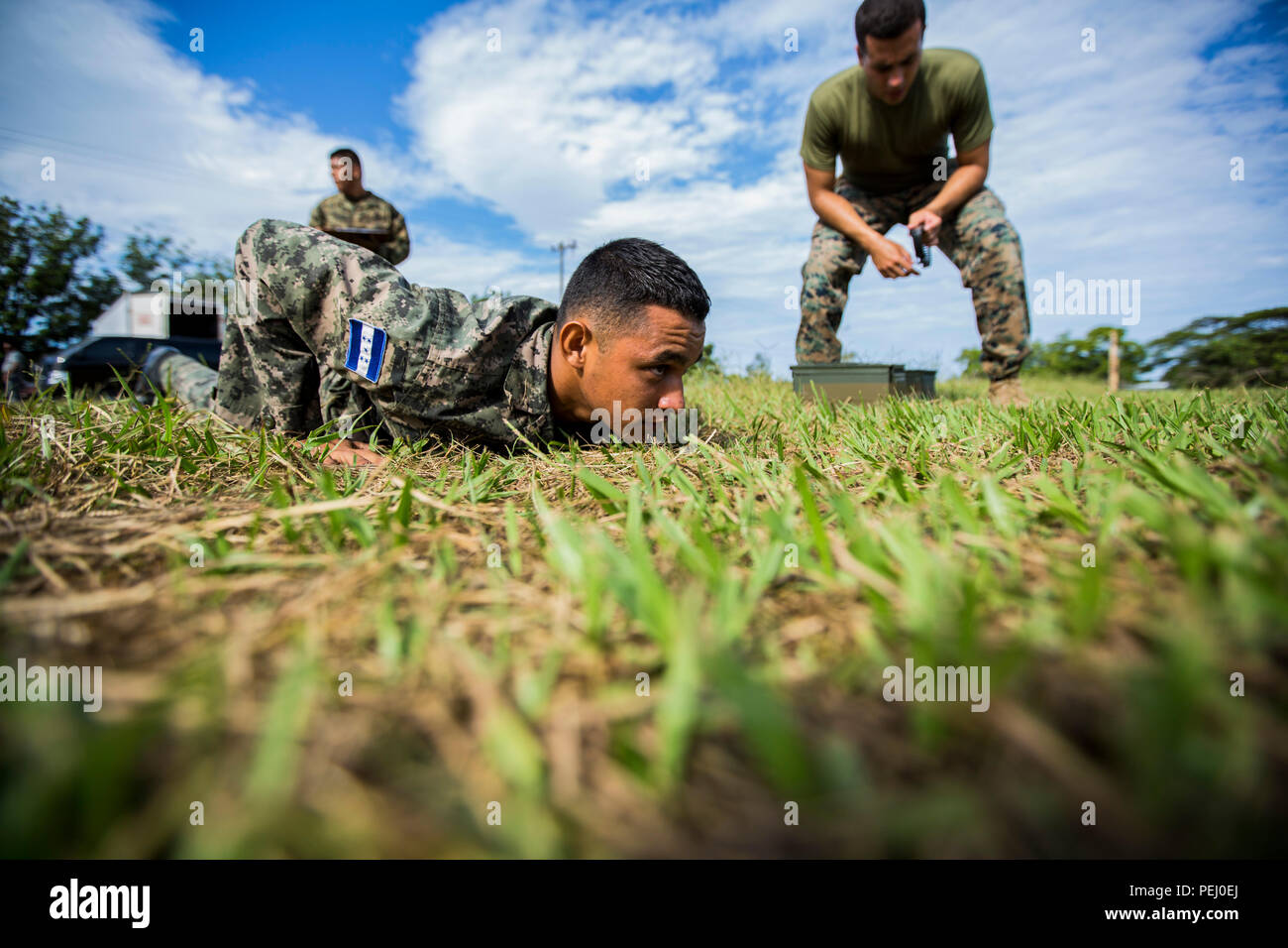U.S. Marine Corps Cpl. Diego Rendon, right, the team leader for Security Cooperation Team-Honduras, Special Purpose Marine Air-Ground Task Force-Southern Command gives a Honduran marine the starting command during the maneuver under fire portion of the combat fitness test at Naval Base Puerto Castilla, Honduras, Aug. 12, 2015. SCT-Honduras is currently deployed as part of the SPMAGTF-SC to assist the Centro de Adiestramiento Naval with implementing a training curriculum to create a Honduran marine Program.  (U.S. Marine Corps Photo by Cpl. Katelyn Hunter/Released). Stock Photo