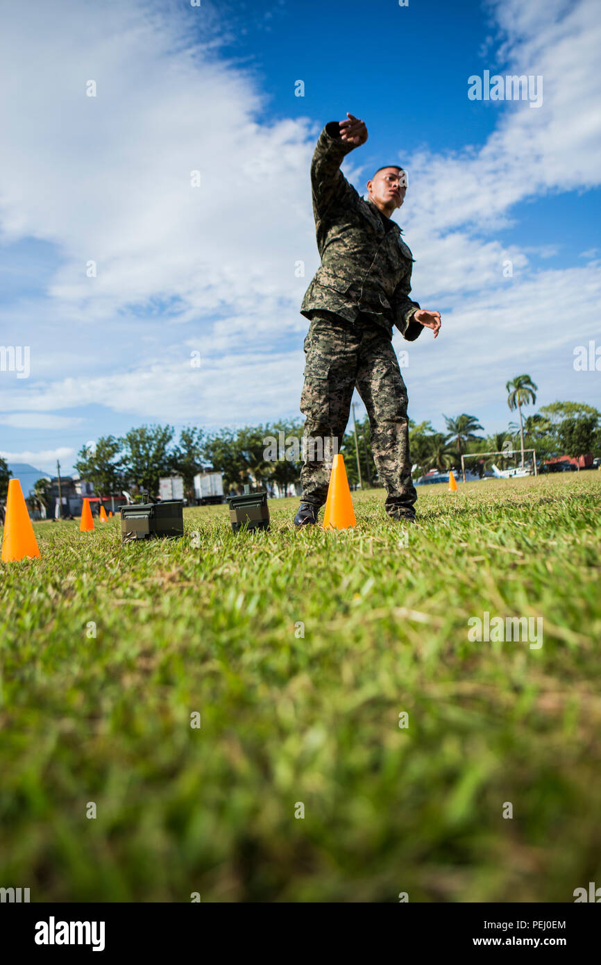 A Honduran marine throws a simulated grenade during the maneuver under fire portion of the combat fitness test at Naval Base Puerto Castilla, Honduras, Aug. 12, 2015. U.S. Marines with Security Cooperation Team-Honduras, Special Purpose Marine Air-Ground Task Force-Southern Command monitored the event. SCT-Honduras is currently deployed as part of the SPMAGTF-SC to assist the Centro de Adiestramiento Naval with implementing a training curriculum to create a Honduran marine Program.  (U.S. Marine Corps Photo by Cpl. Katelyn Hunter/Released). Stock Photo