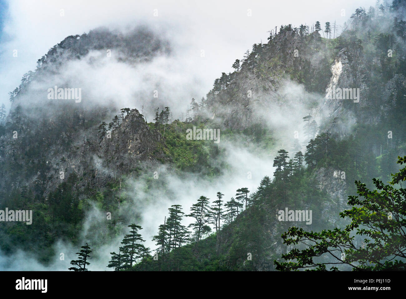 Clouds partially cover the wild and dramatic Albanian Alps, also known as the Accursed Mountains,  in The Valbone Valley National Park, North eastern  Stock Photo