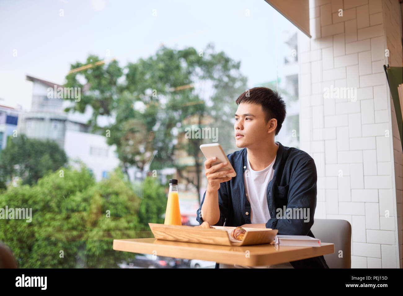Men use phone on tea time,using mobile smart phone, Internet of things lifestyle with wireless communication and internet with smartphone. Stock Photo