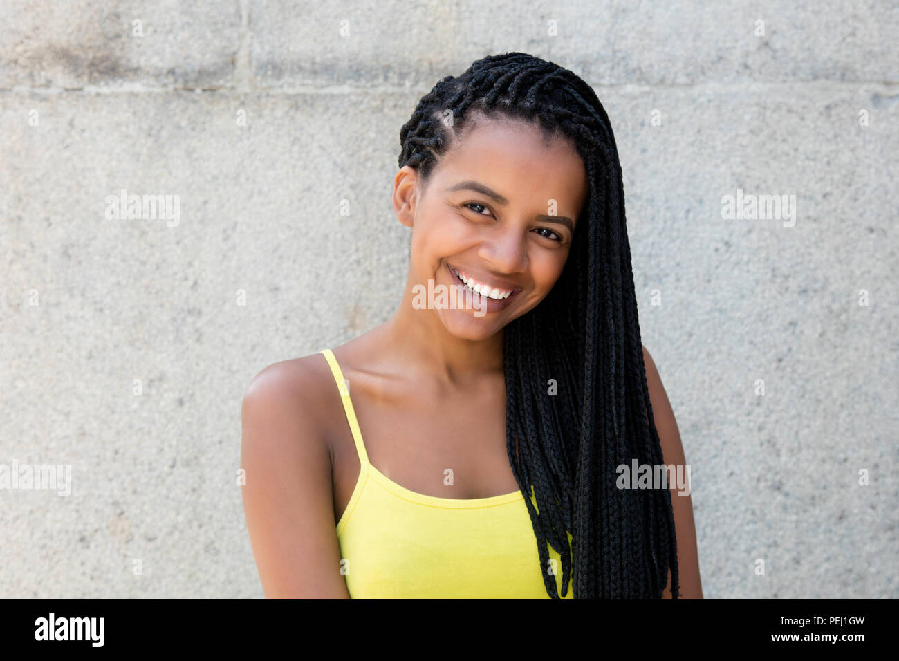 Portrait of a beautiful african american woman with dreadlocks outdoors ...