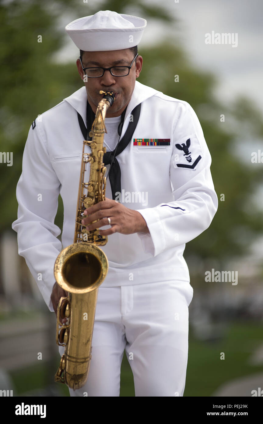 150826-N-CI175-071 DETROIT, Mich. (Aug. 26, 2015) Musician 3rd Class Jason Gay, assigned to the Navy Band Great Lakes Brass Band, plays in a concert along Detroit’s downtown RiverWalk as part of Detroit Navy Week. Navy Weeks focus a variety of assets, equipment and personnel on a single city for a week-long series of engagements designed to bring America's Navy closer to the people it protects, in cities that don't have a large naval presence. (U.S. Navy photo by Mass Communication Specialist 1st Class Jon Rasmussen/Released) Stock Photo
