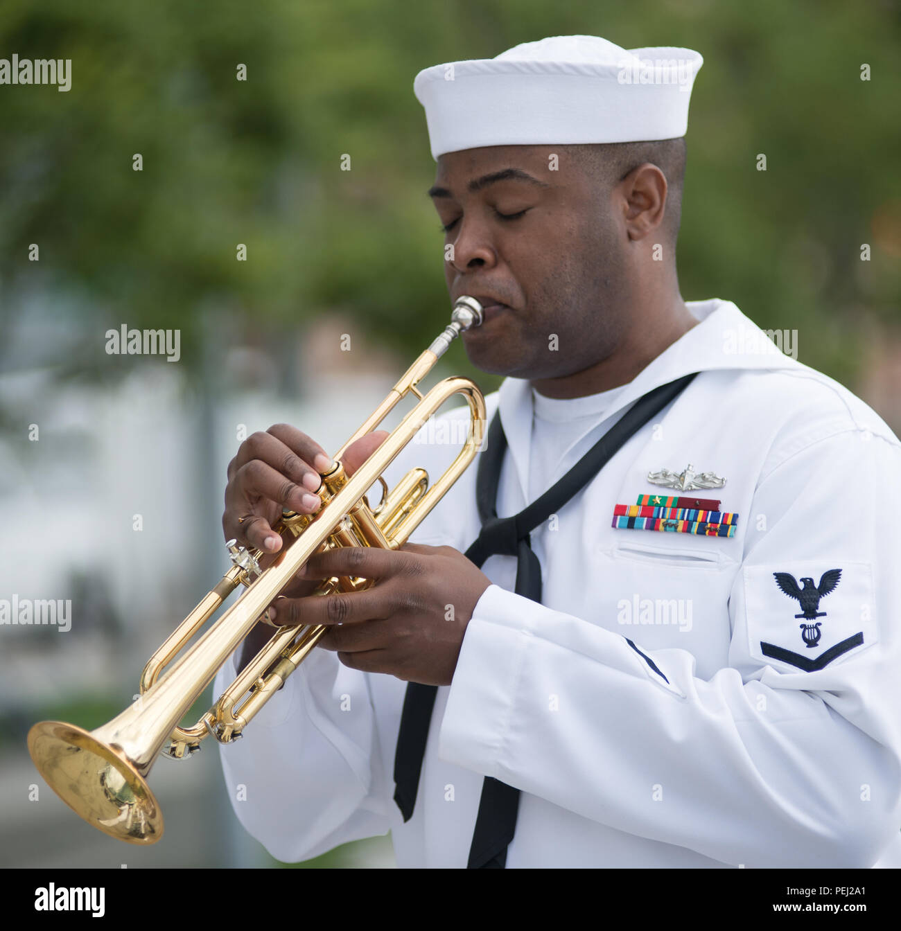 150826-N-CI175-095 DETROIT, Mich. (Aug. 26, 2015) Musician 3rd Class (SW) Michael Bookman, assigned to the Navy Band Great Lakes Brass Band, plays in a concert along Detroit’s downtown RiverWalk as part of Detroit Navy Week. Navy Weeks focus a variety of assets, equipment and personnel on a single city for a week-long series of engagements designed to bring America's Navy closer to the people it protects, in cities that don't have a large naval presence. (U.S. Navy photo by Mass Communication Specialist 1st Class Jon Rasmussen/Released) Stock Photo