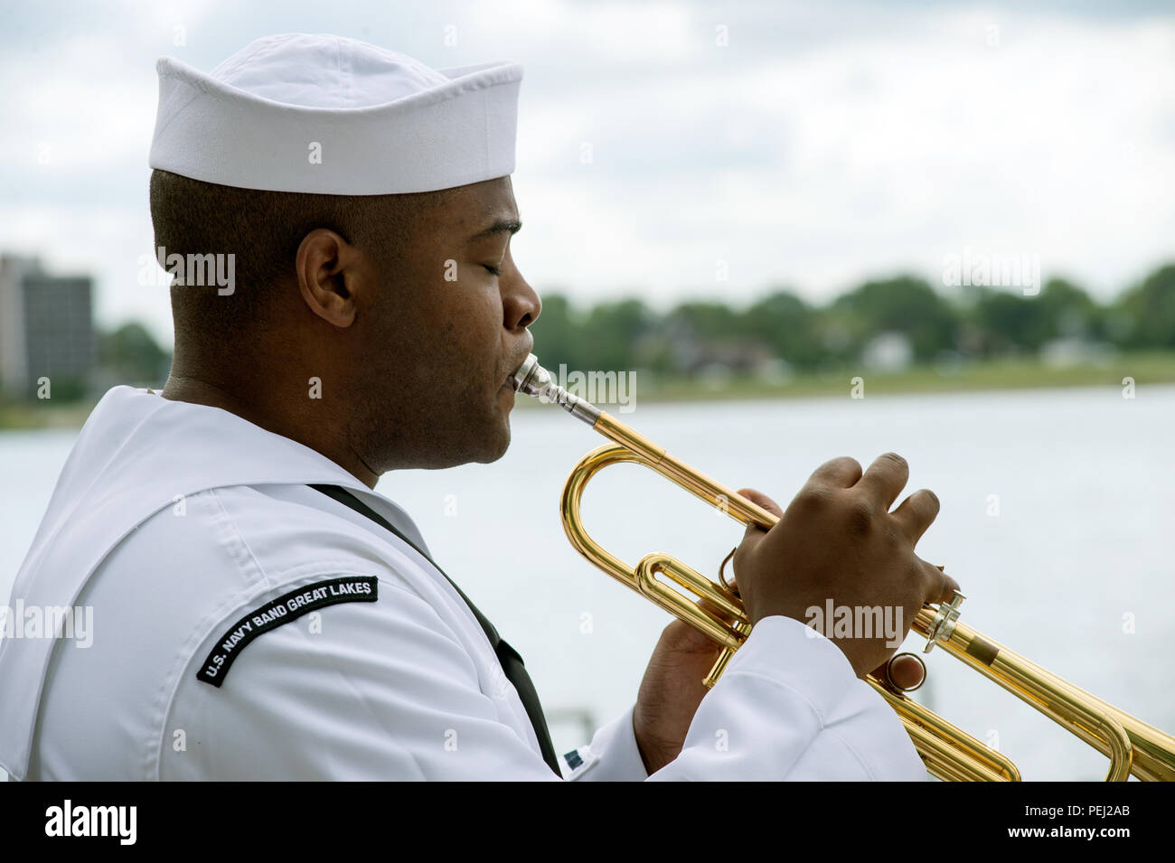 150826-N-CI175-144 DETROIT, Mich. (Aug. 26, 2015) Musician 3rd Class (SW) Michael Bookman, assigned to the Navy Band Great Lakes Brass Band, plays in a concert along Detroit’s downtown RiverWalk as part of Detroit Navy Week. Navy Weeks focus a variety of assets, equipment and personnel on a single city for a week-long series of engagements designed to bring America's Navy closer to the people it protects, in cities that don't have a large naval presence. (U.S. Navy photo by Mass Communication Specialist 1st Class Jon Rasmussen/Released) Stock Photo