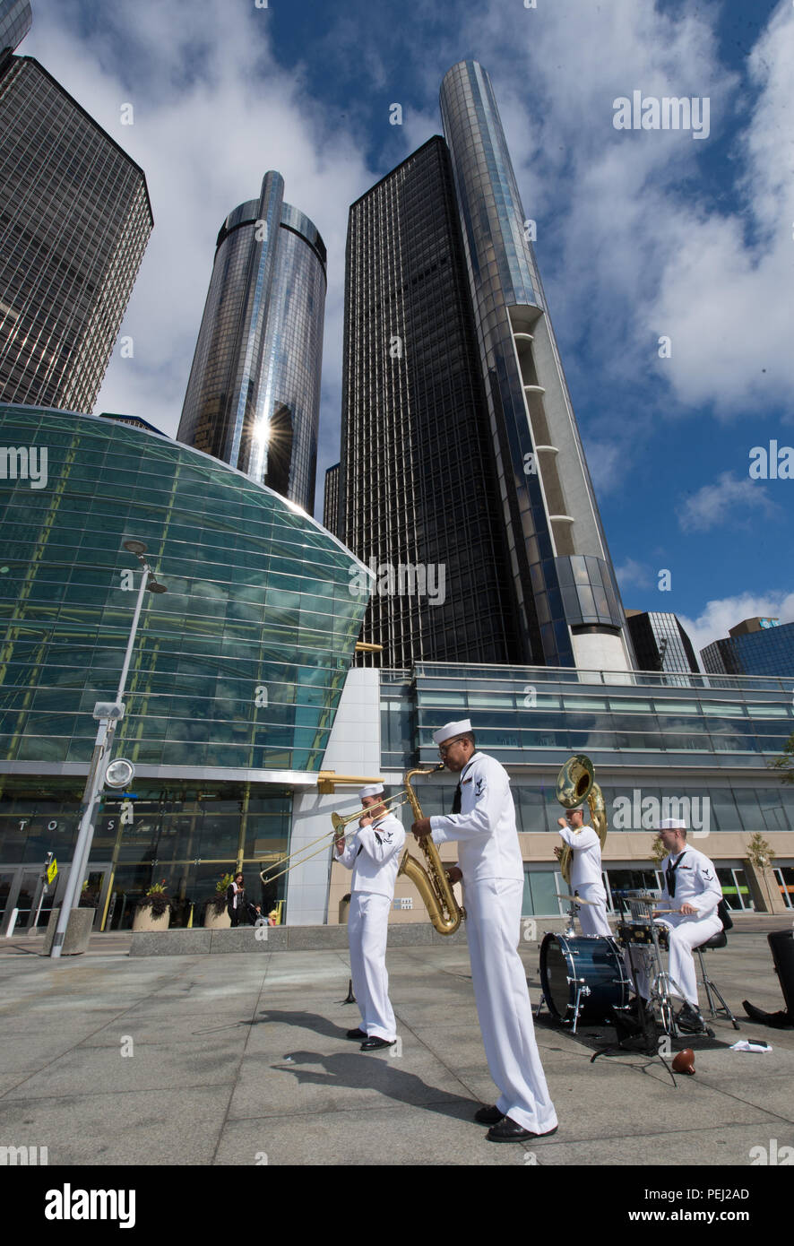 150826-N-CI175-001 DETROIT, Mich. (Aug. 26, 2015) Musicians assigned to the Navy Band Great Lakes Brass Band perform in front of the Renaissance Center along Detroit’s downtown RiverWalk as part of Detroit Navy Week. Navy Weeks focus a variety of assets, equipment and personnel on a single city for a week-long series of engagements designed to bring America's Navy closer to the people it protects, in cities that don't have a large naval presence. (U.S. Navy photo by Mass Communication Specialist 1st Class Jon Rasmussen/Released) Stock Photo