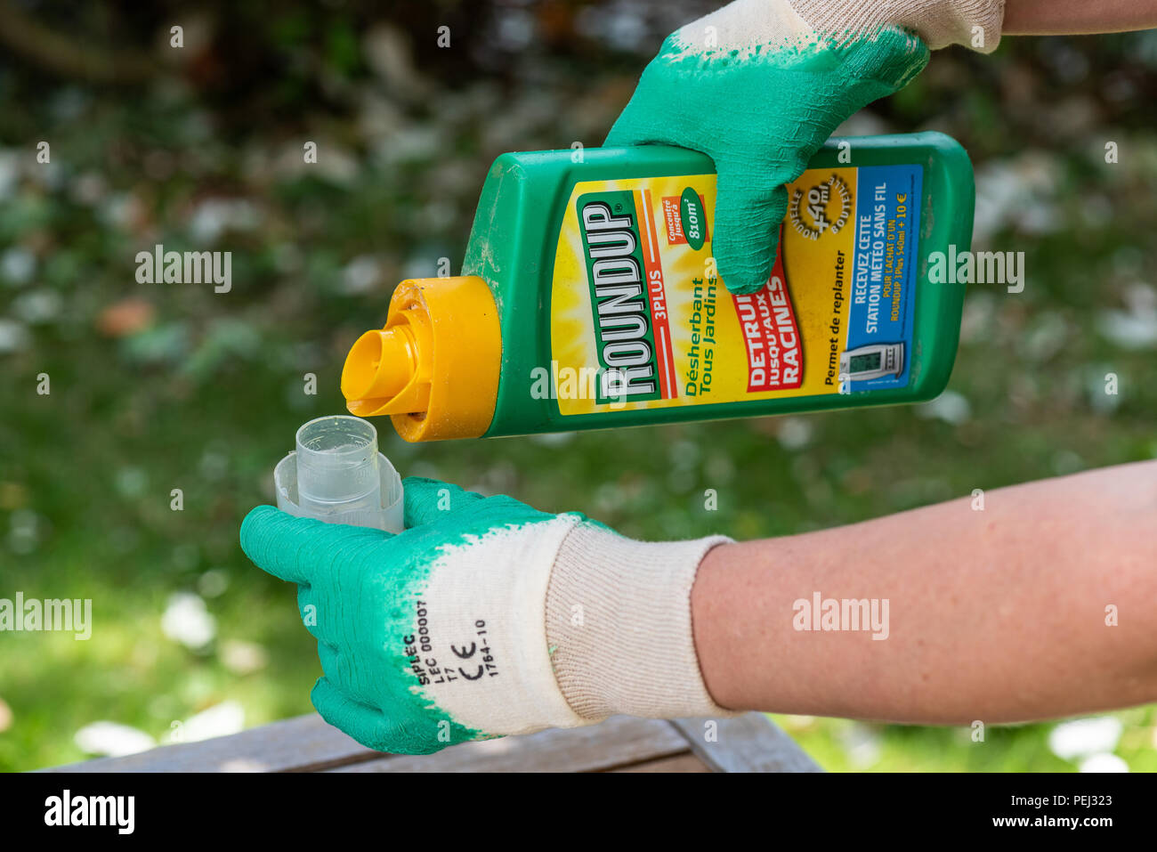 Paris, France - August 15, 2018 : Gardener using Roundup herbicide in a ...
