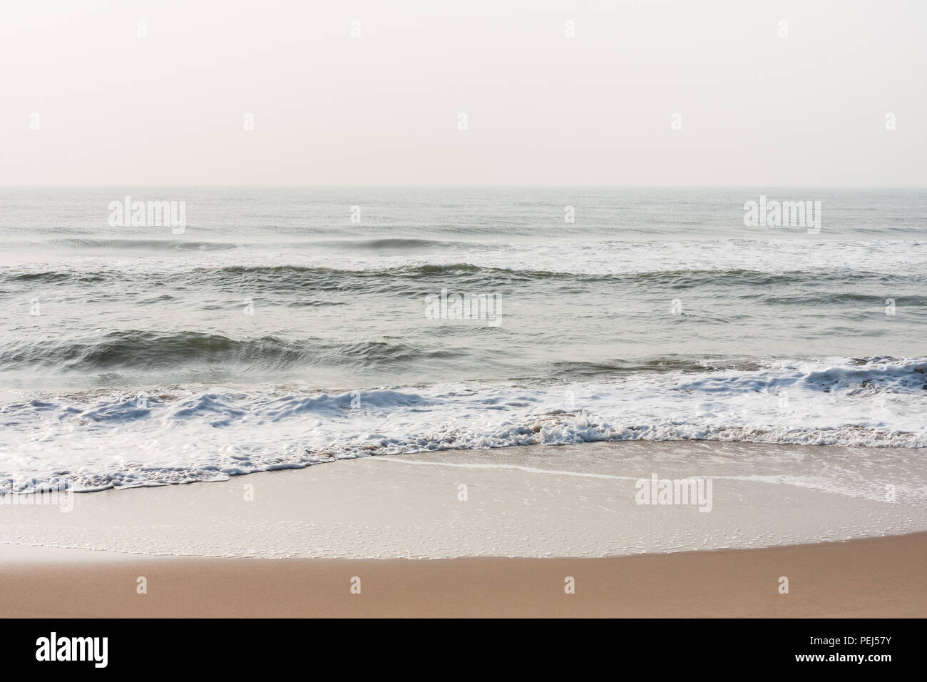 Foamy water on calm beach Foamy water at morning time on a tropical