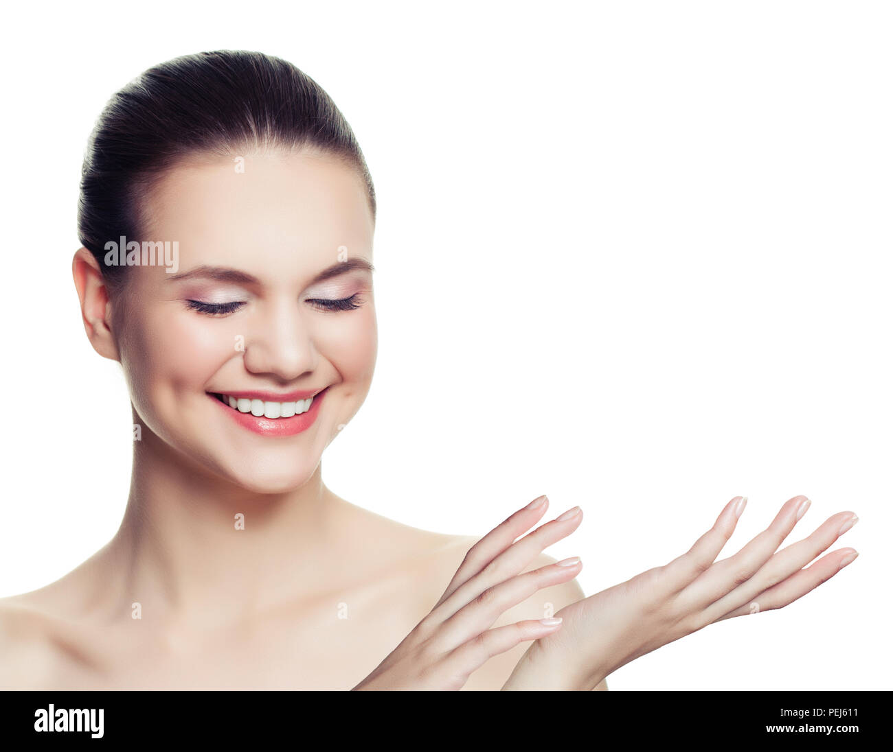 Young smiling woman showing empty copy space on the open hand isolated ...