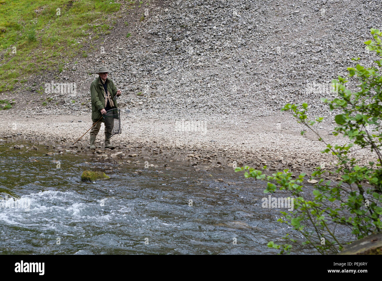 Fly-fishing on the River Dove near Thorpe Cloud, Dovedale, Derbyshire Stock Photo