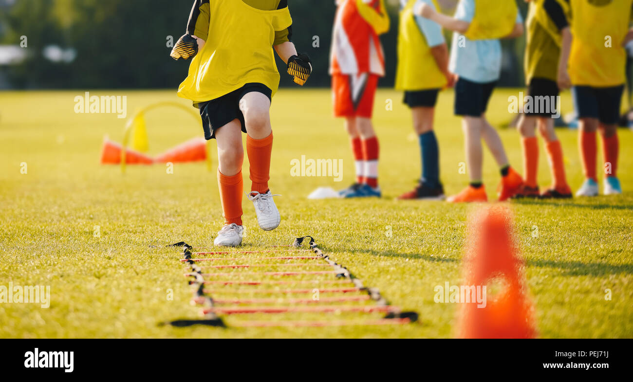 Young Athletes Training with Football Equipment. Football Speed