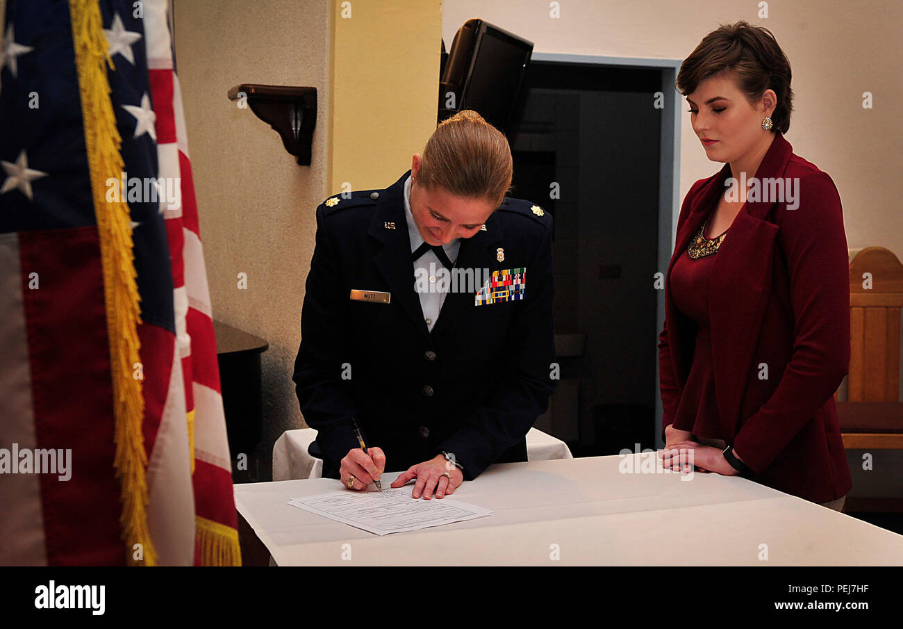 Maj. Brittany Nutt, 86th Medical Squadron women’s health nurse practitioner, and her daughter, Kiersten Nutt, sign Kiersten’s contract after her final swear-in Nov. 23, 2015, at Landstuhl Regional Medical Center, Germany. Kiersten left for basic military training the following day and will be going into radio frequency transmissions. (U.S. Air Force photo/Airman 1st Class Larissa Greatwood) Stock Photo