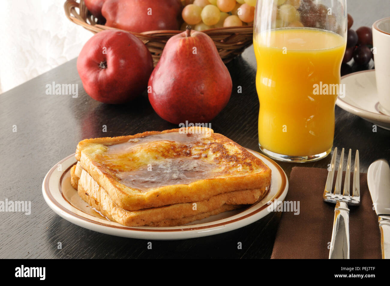 French Toast With A Basket Of Fruit And Orange Juice Stock Photo Alamy