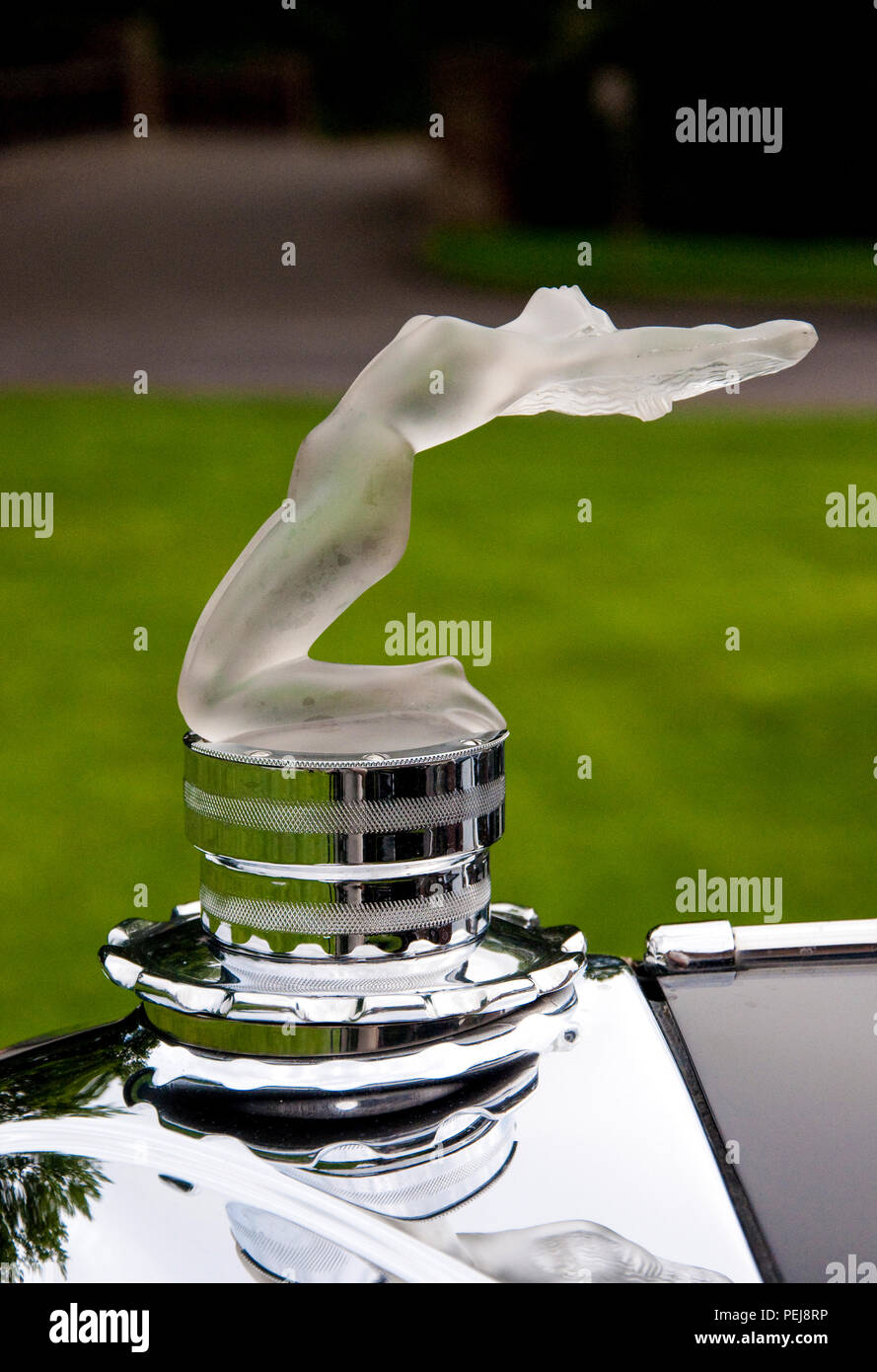 1931 Lalique Hood Ornament / Mascot “Chris” frosted white pressed glass on a Marcilhac radiator chrome cover. Stock Photo