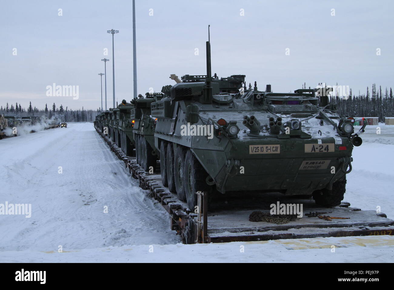 Strykers and other vehicles wait to be driven off train cars at Fort Wainwright, Alaska, Dec. 9