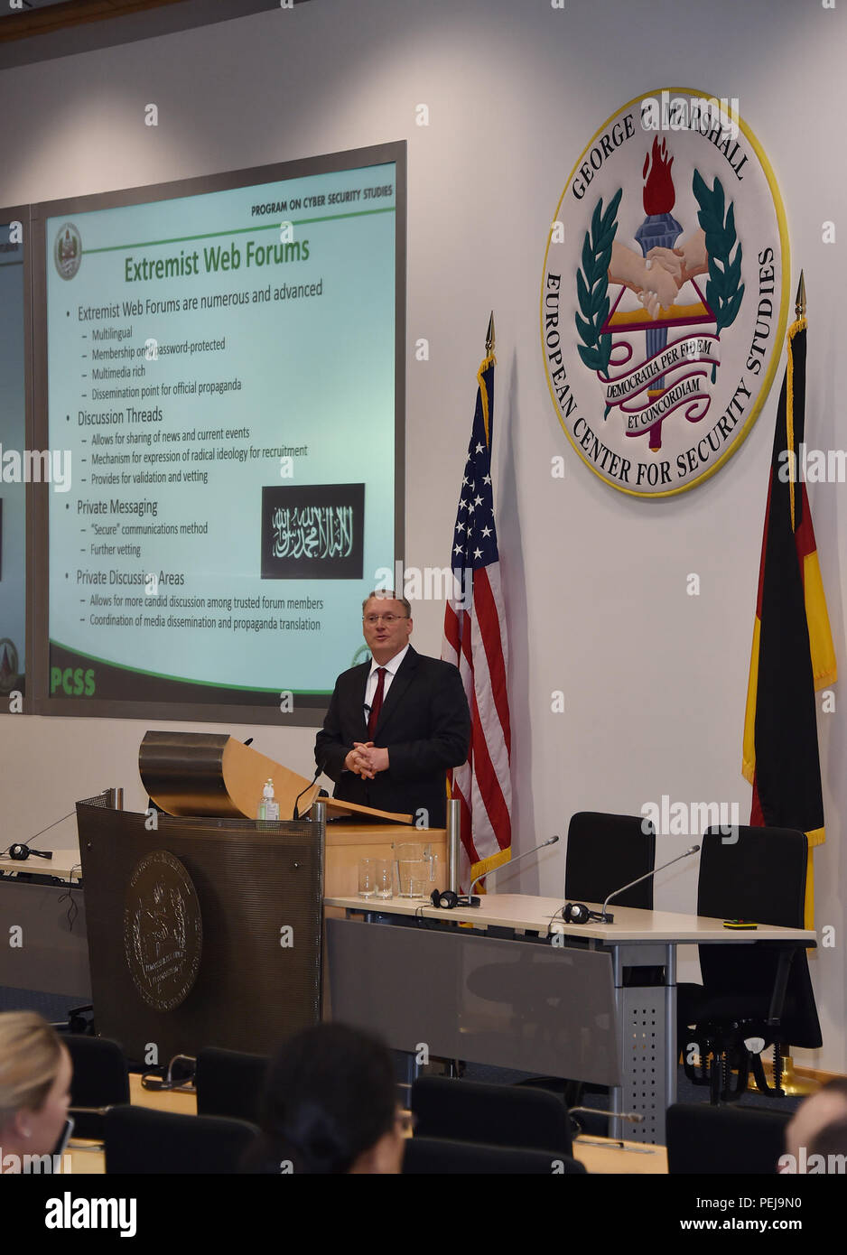 Program for Cyber Security Studies director Professor Phil Lark gives participants an overview of how terrorist groups use the internet for various operations from financing to recruiting. PCSS is a unique, two-week program on cyber security studies offered once a year at the George C. Marshall European Center in Garmisch-Partenkirchen, Germany. The course brings together international government and military leaders to reach a shared understanding of international and country specific approaches to a more secure, global cyber network and build partnerships to resolve shared challenges. Stock Photo