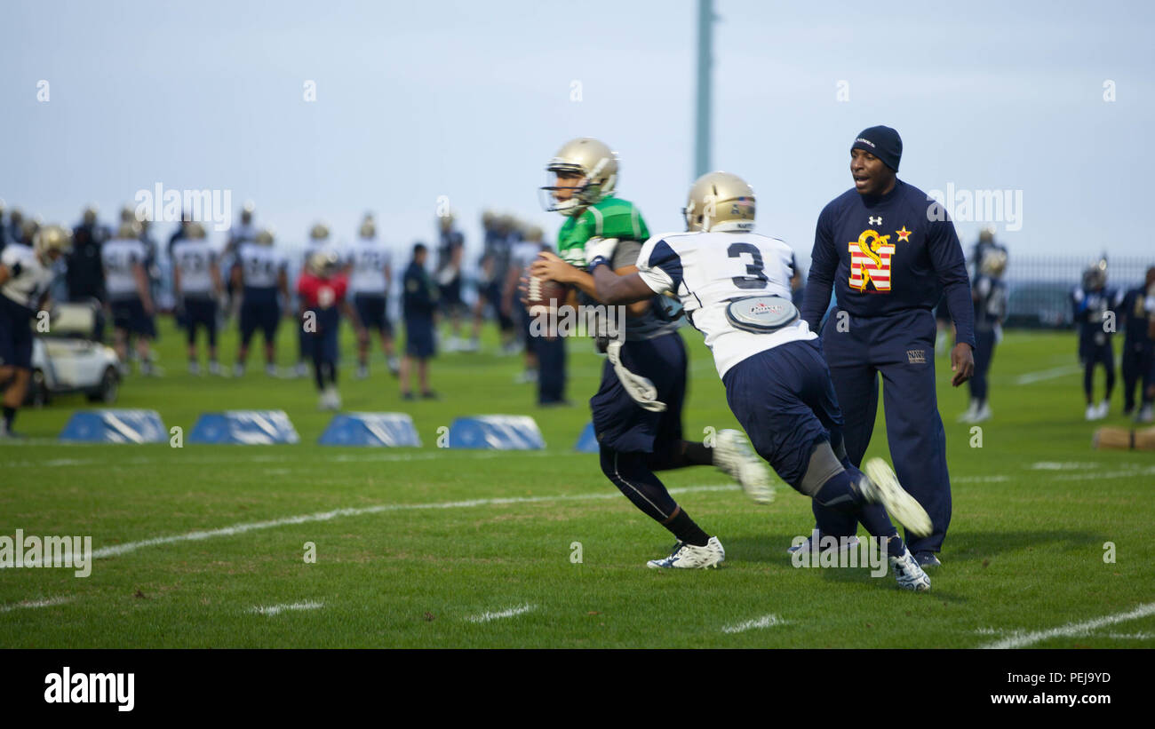 Lt. Col. Robert B. Green runs football players through drills during practice Nov. 17, 2015, at the U.S. Naval Academy in Annapolis, Maryland. Green recently was appointed the outside linebacker coach of the team. Green is a Naval Academy graduate, and played on the football team as a defensive back during the 1993-1996 seasons. Stock Photo