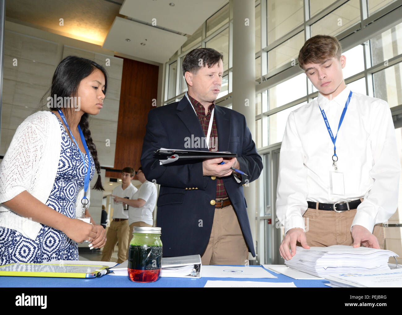 Russ Dunford, U.S. Army Engineering and Support Center, Huntsville chief of operations, speaks to McCoy Floyd, left, and Zachery Amerson, Palmetto Scholars Academy, North Charleston, South Carolina, about their conceptual payload during the InSPIRESS event at UA Huntsville, Dec. 11. Stock Photo