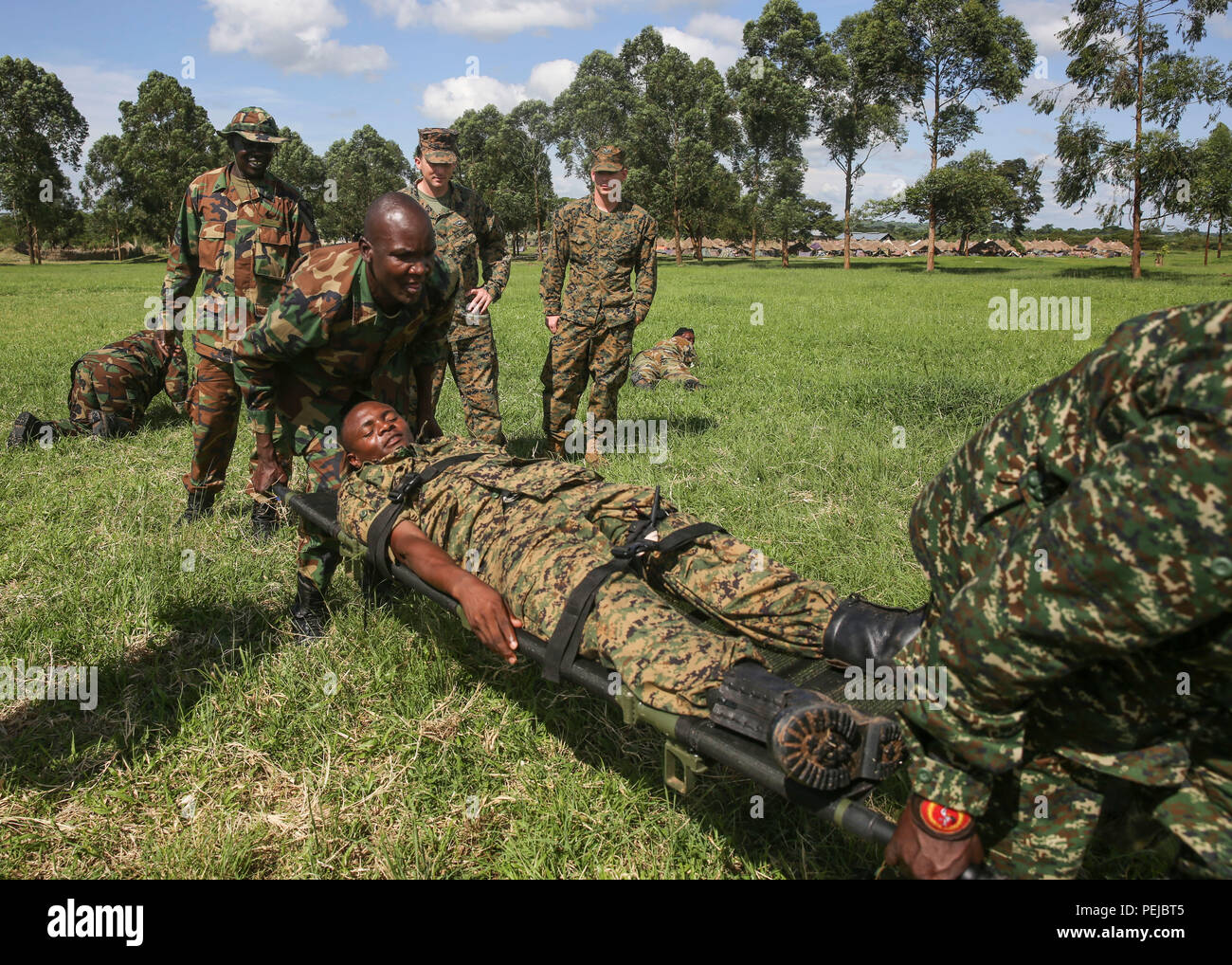 Uganda People's Defense Force soldiers carry a notional injured soldier to  a safe area during a tactical combat casualty care exercise at Camp Singo,  Uganda, Nov. 30, 2015. The UPDF medics and