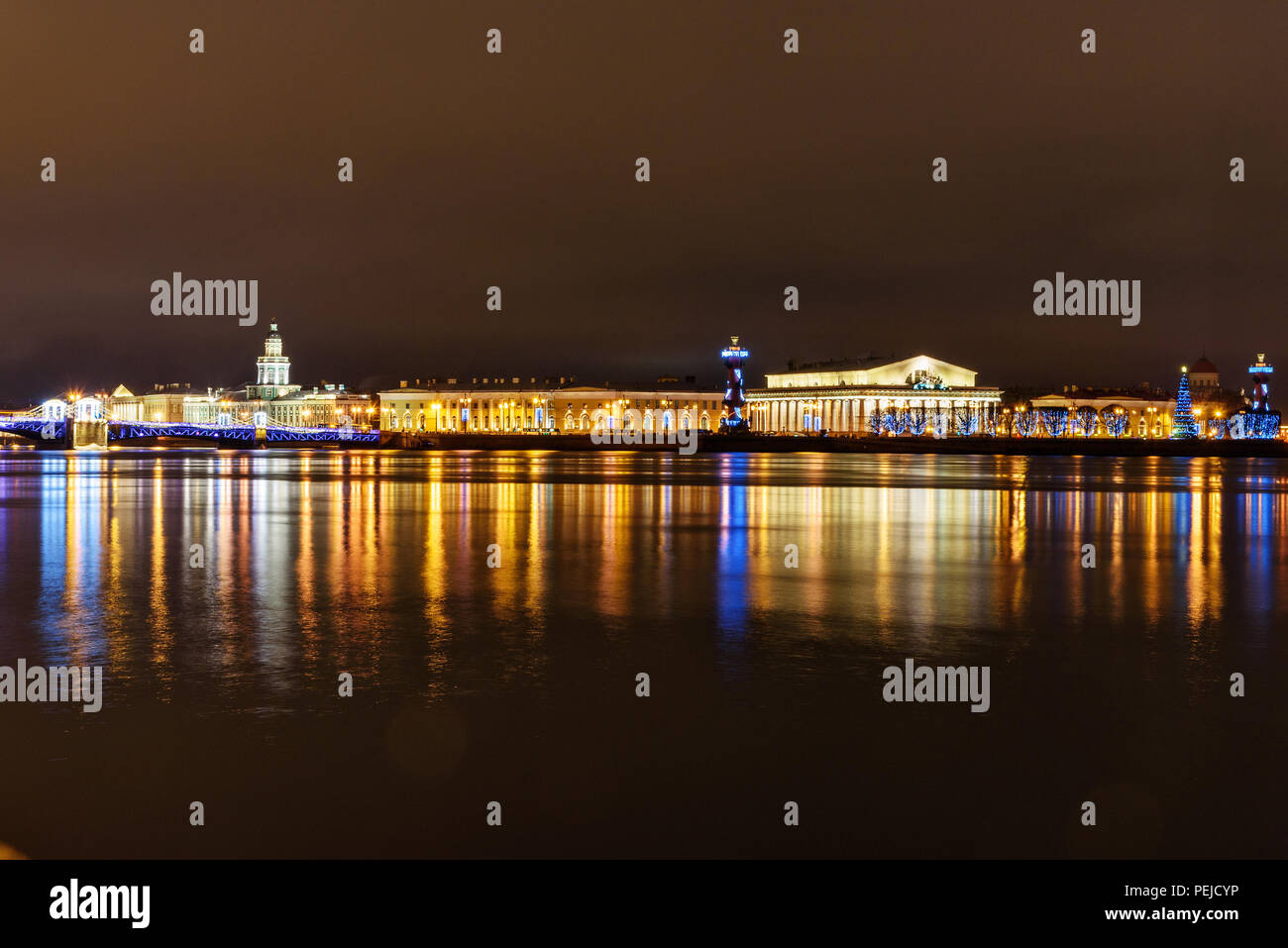 Palace Bridge and Vasilyevsky island Spit Strelka with Rostral columns at night. New Year and Christmas illumunated. Saint Petersburg, Russia Stock Photo
