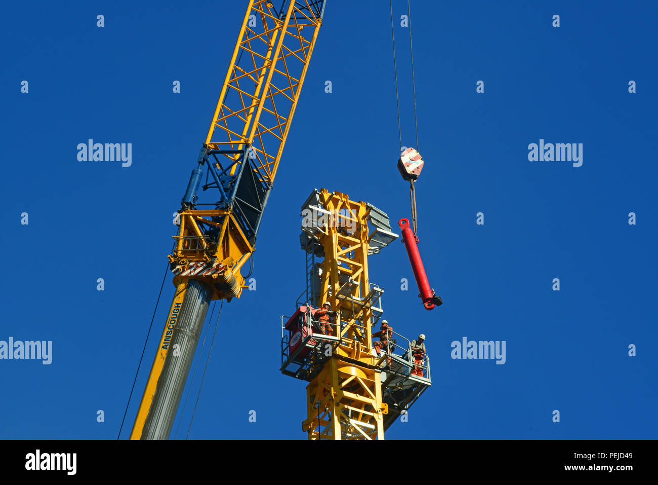 construction workers assembling giant crane on building site in leeds yorkshire united kingdom Stock Photo