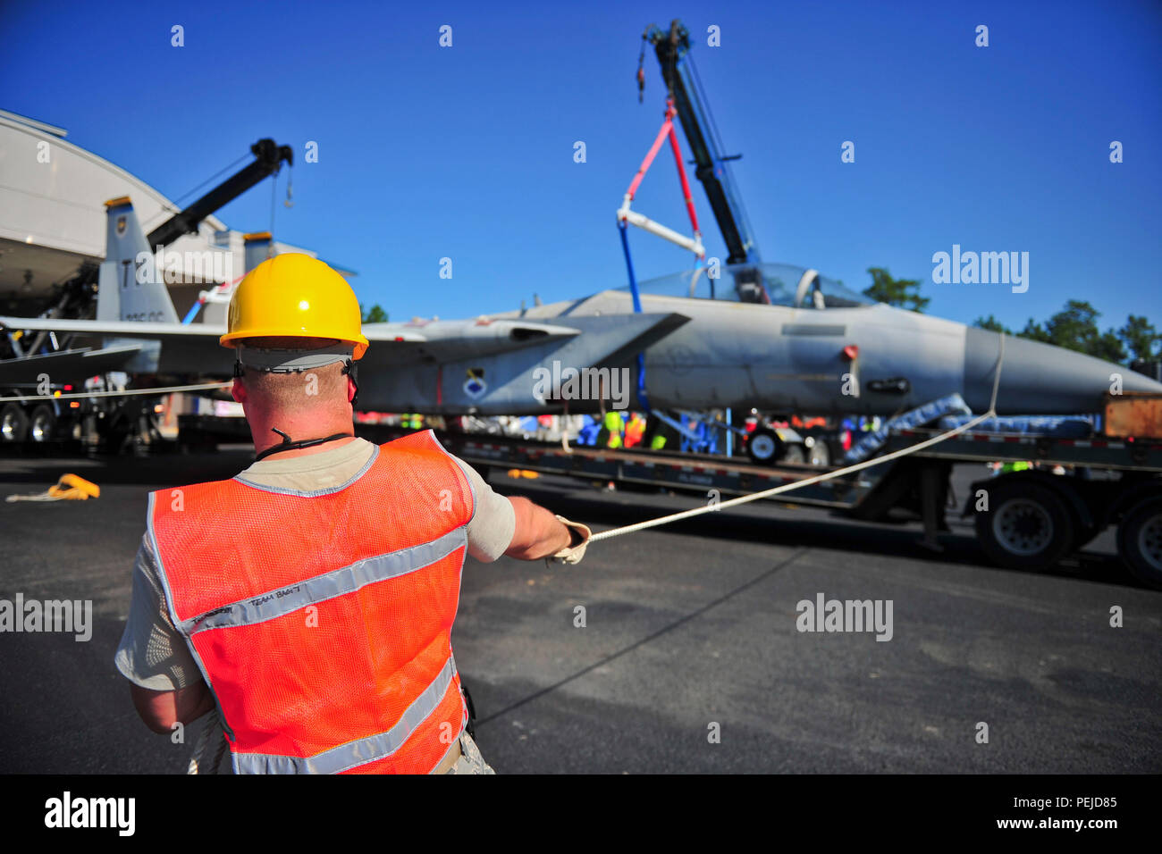 An F15C Eagle is lifted off a flatbed semitruck at Haney Technical