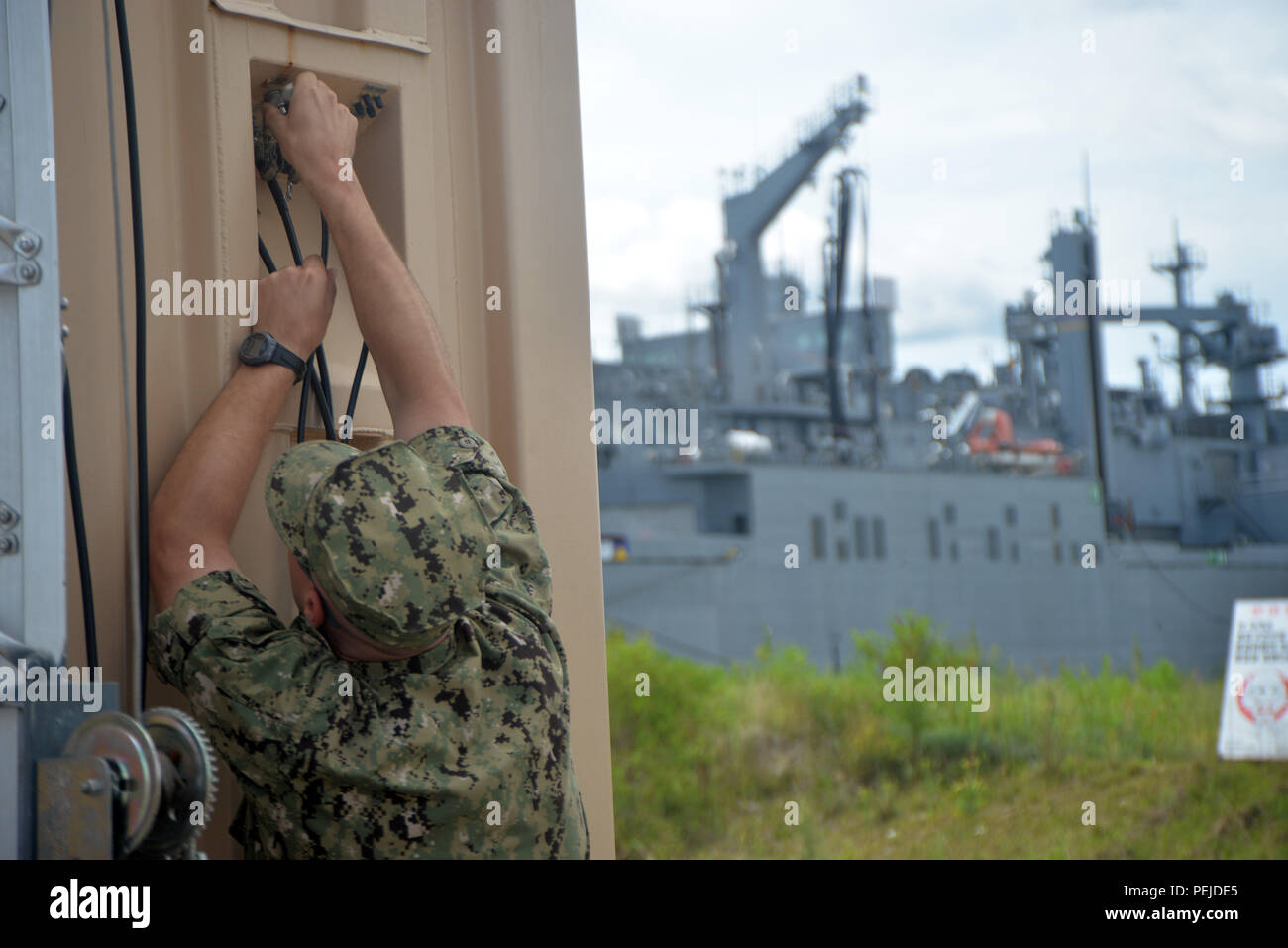 A Sailor installs a coaxial cable on the Mobile Sealift Operations ...
