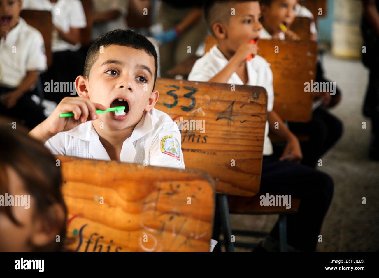Students from Jairo Ayala School in Trujillo, Honduras practice brushing their teeth during a dental hygiene class given by the U.S. Navy on Aug. 31, 2015.  Members of the U.S. Navy donated shoes to the students and taught dental and general hygiene classes in support of Operation Continuing Promise. Operation Continuing Promise is a mission in which the United States military works with host nations to provide humanitarian assistance and execute civil-military operations alongside various partner nations within the Caribbean and Central and South America. (U.S. Marine Corps photo by Cpl. Kirs Stock Photo