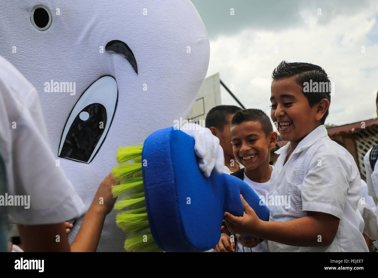 A student practices brushing a giant tooth at Jairo Ayala School on Aug. 31, 2015.  Members of the U.S. Navy donated shoes to the students and taught dental and general hygiene classes in support of Operation Continuing Promise. Operation Continuing Promise is a mission in which the United States military works with host nations to provide humanitarian assistance and execute civil-military operations alongside various partner nations within the Caribbean and Central and South America. (U.S. Marine Corps photo by Cpl. Kirstin Merrimarahajara/released) Stock Photo