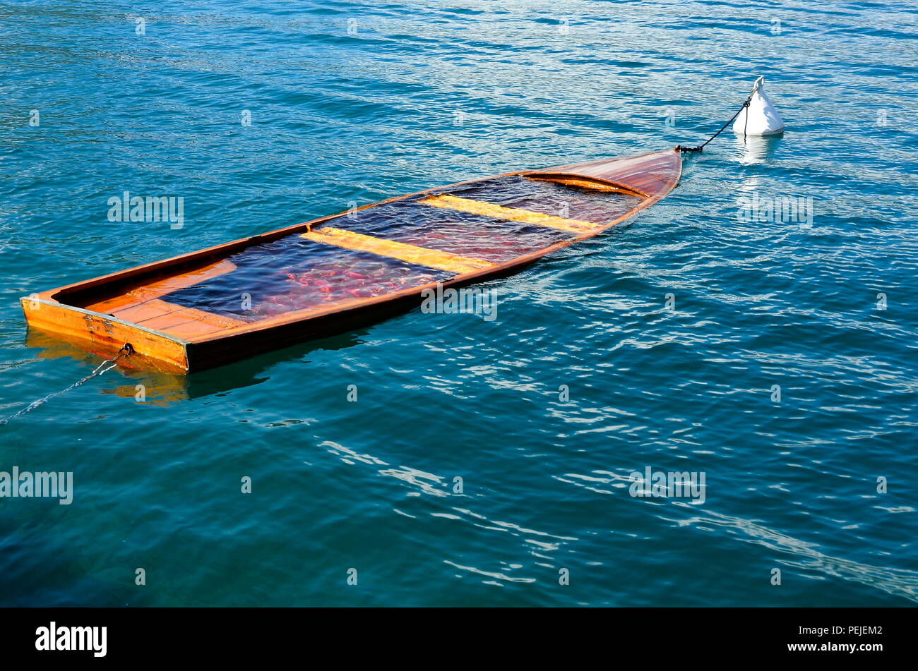 Small boat is sinking in the sea Stock Photo